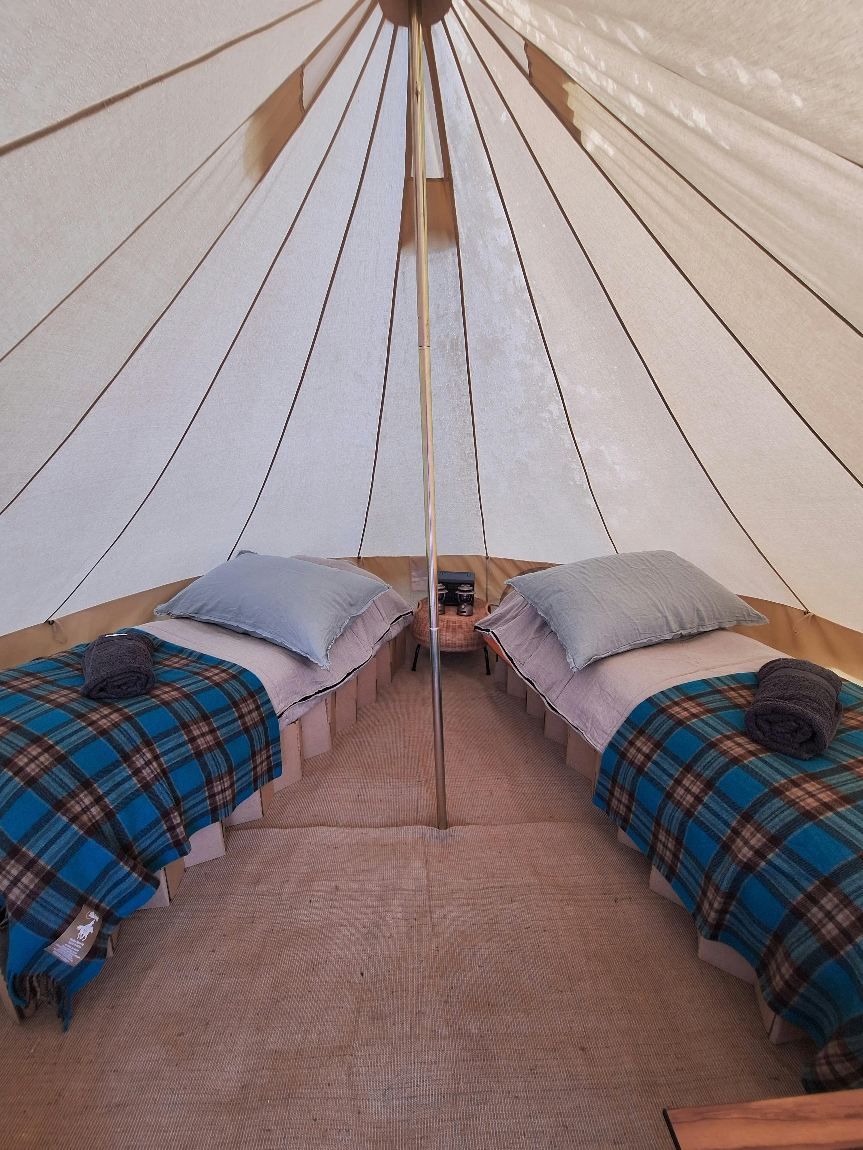 inside a glamping tent with two beds