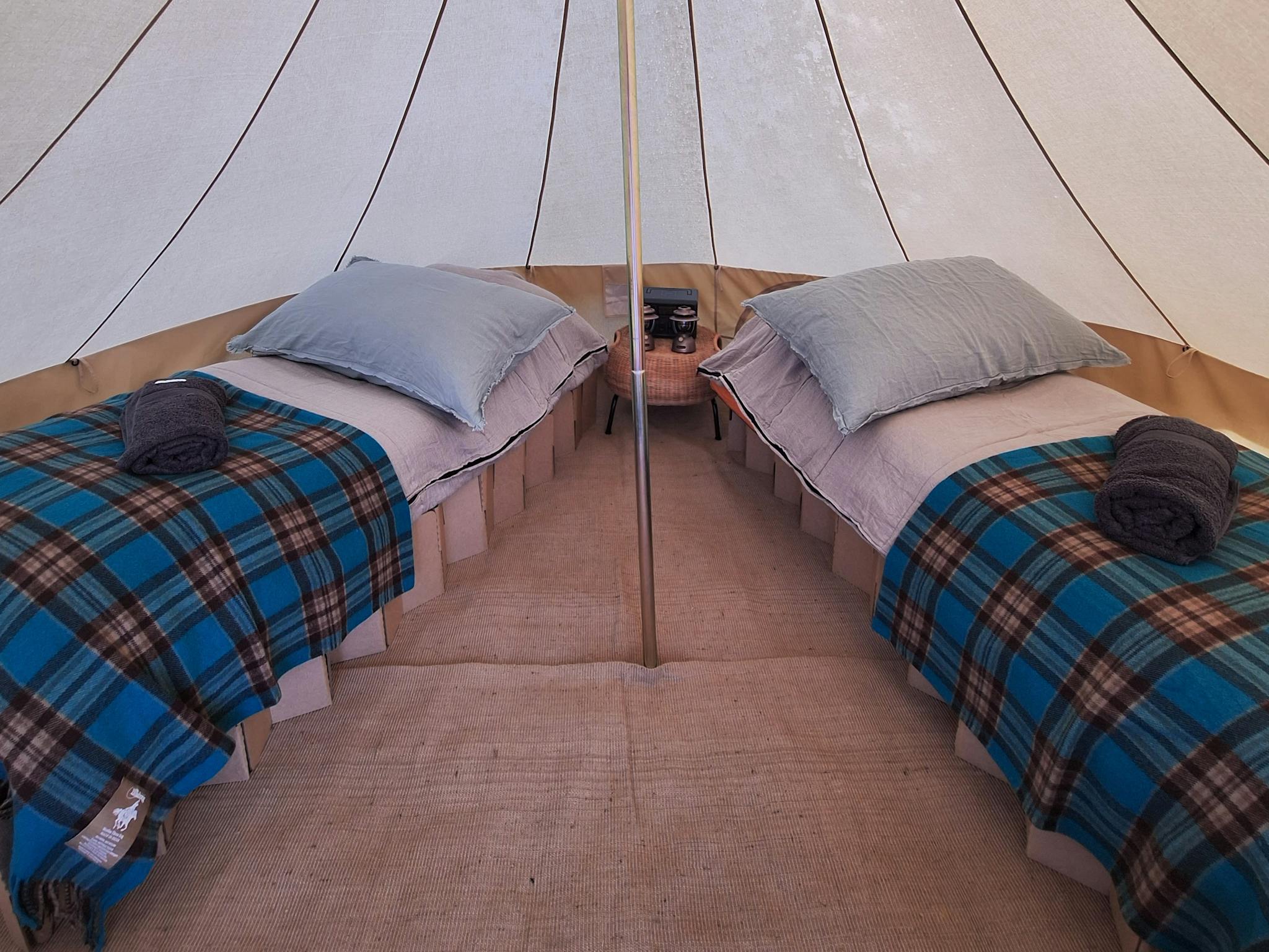 inside a glamping tent with two beds