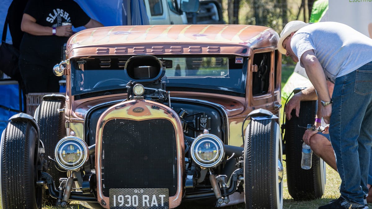 men looking at hot rod