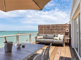 Outdoor seating and dining on an ocean-front raised deck.  You will feel like you are on the water.