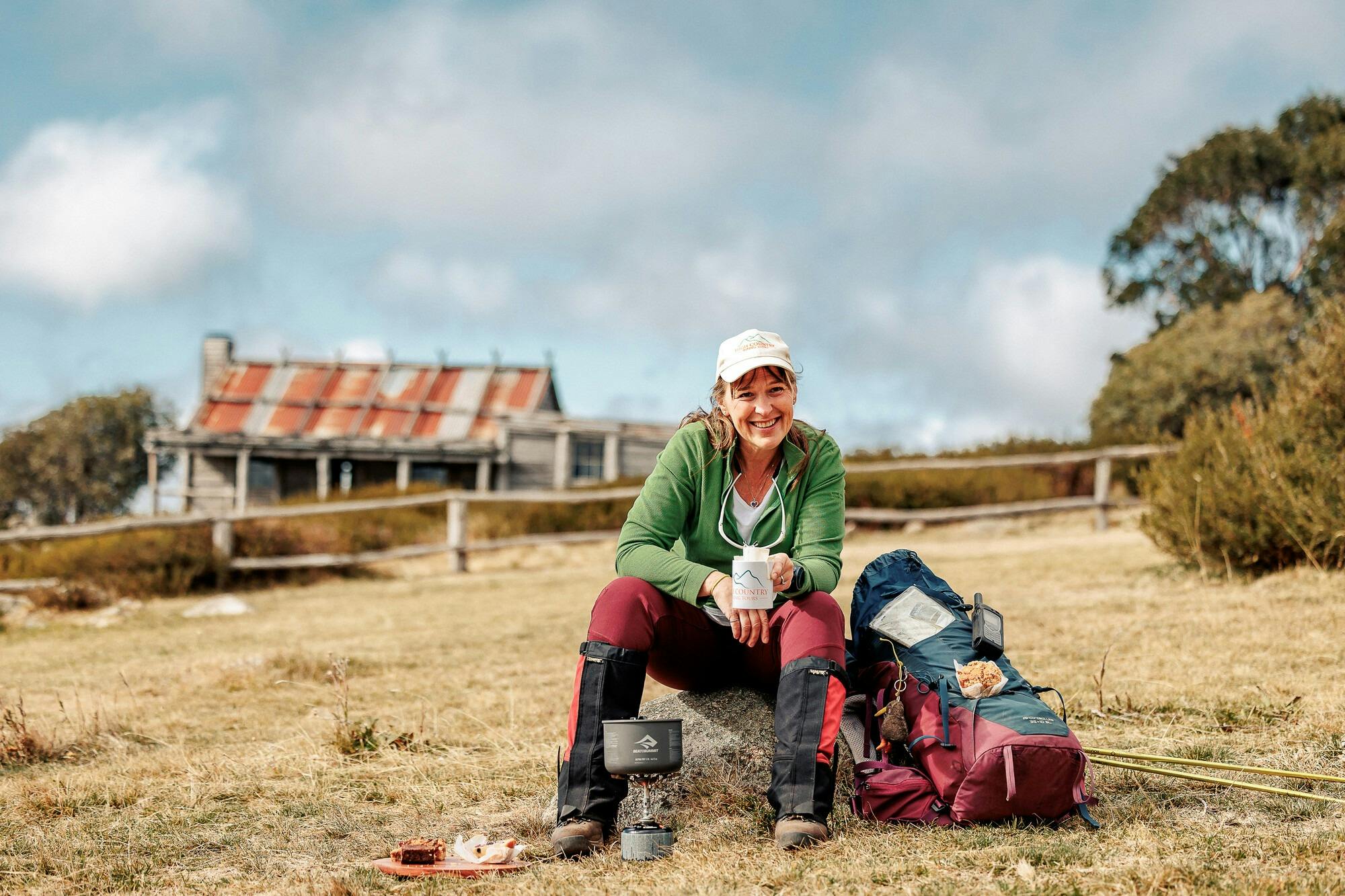 A hiker is enjoying a snack at Craig's Hut