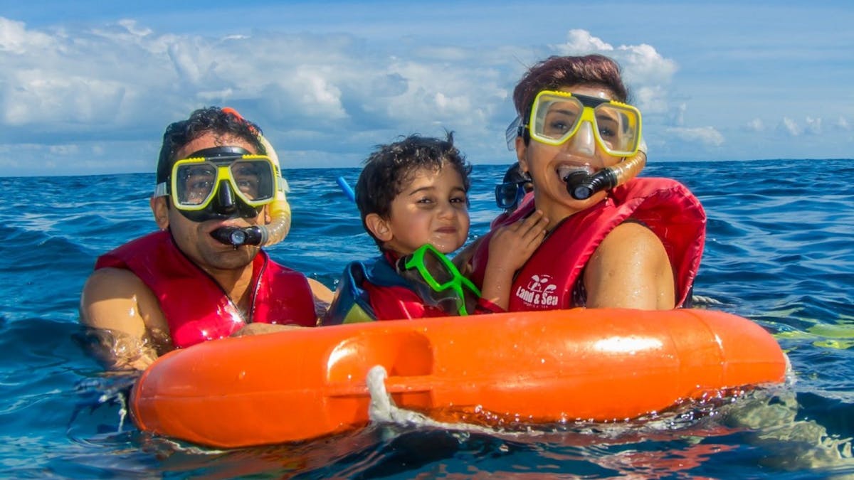 Family sorkeling on the Great Barrier Reef with Reef Experience friendly crew