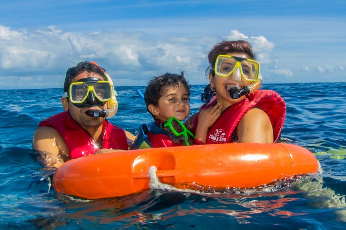 Family sorkeling on the Great Barrier Reef with Reef Experience friendly crew