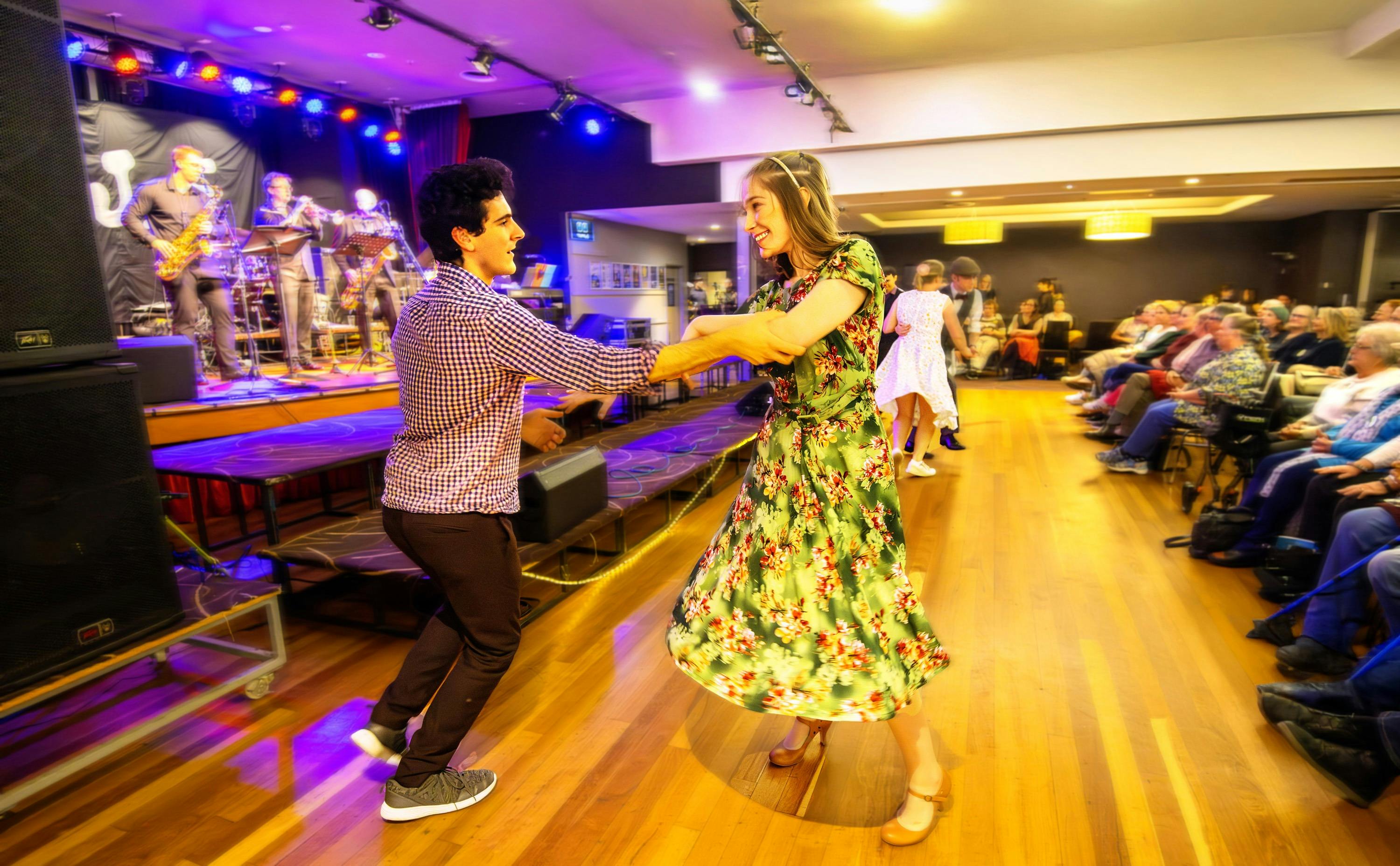 Dancers in front of a big band and busy auditorium at Club Sapphire Merimbula, one of eight venues.