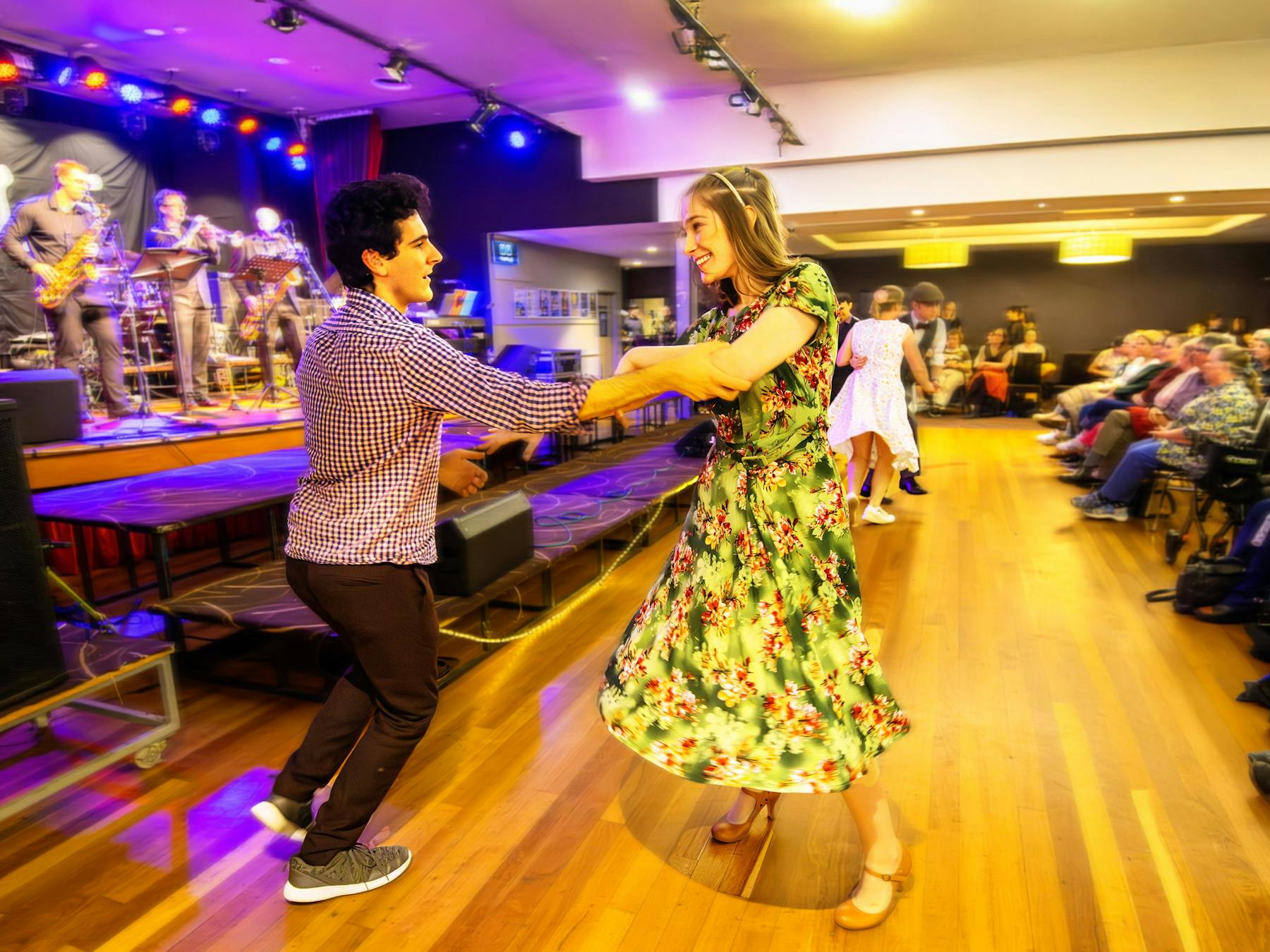 Dancers in front of a big band and busy auditorium at Club Sapphire Merimbula, one of eight venues.