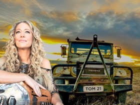 Jodi Martin and Tommy the Toyota celebrating 25 Years of Music in 2025 by saying: Never Say Die!