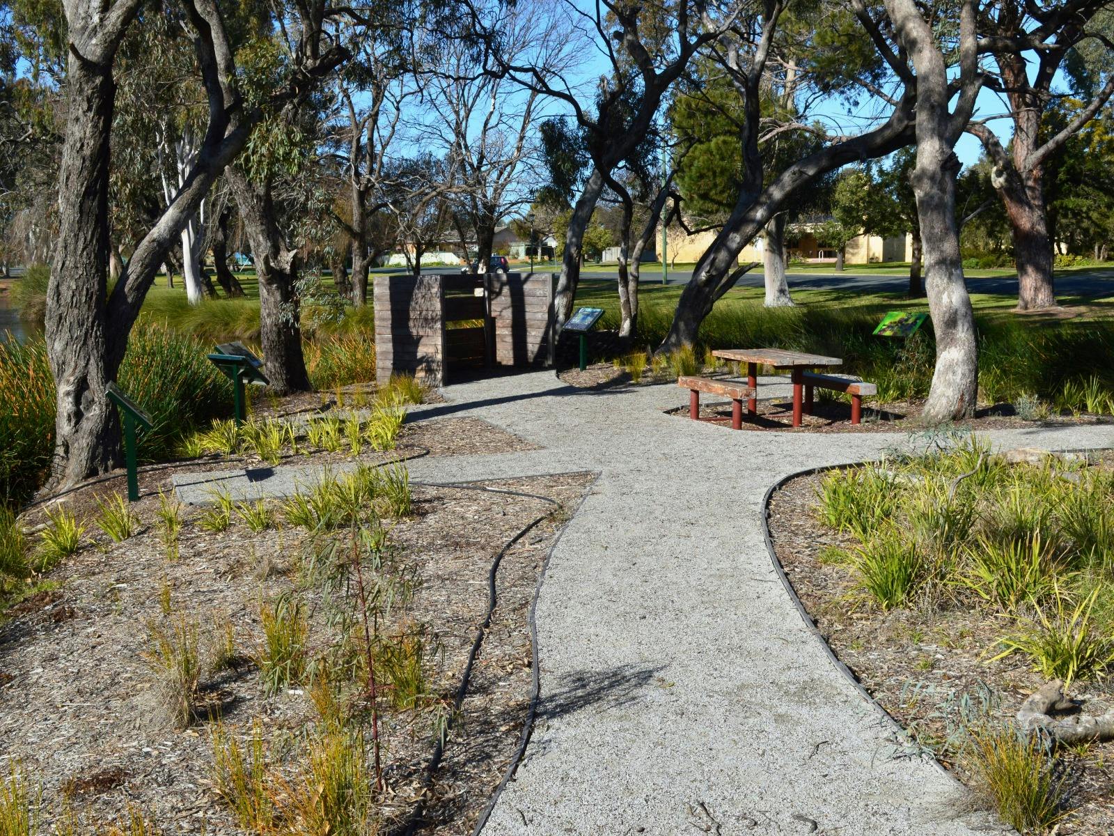 Park pathways lead to a bird hide and seating area