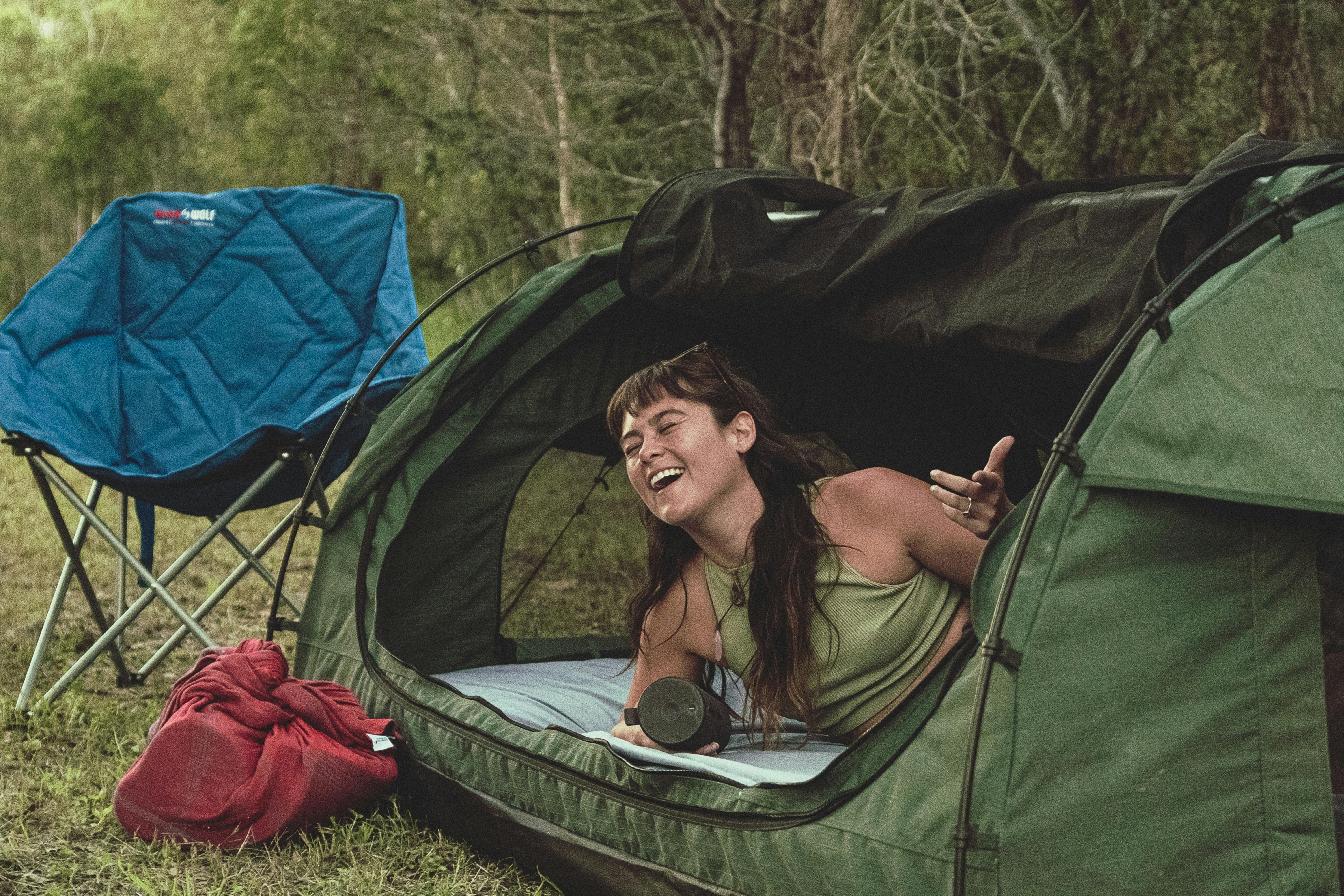 girl waking up in a swag, refreshed after a comfortable nights sleep.