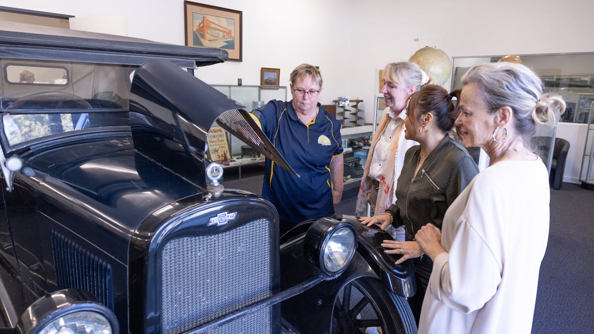 visitors admiring the 1926 chevrolet sedan donated by the Pettigrew family