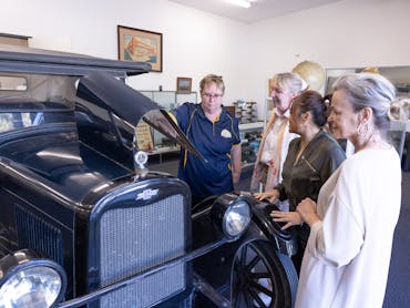 visitors admiring the 1926 chevrolet sedan donated by the Pettigrew family