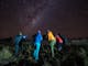 A group of hikers receiving astrophotography lesson at Craig's Hut.