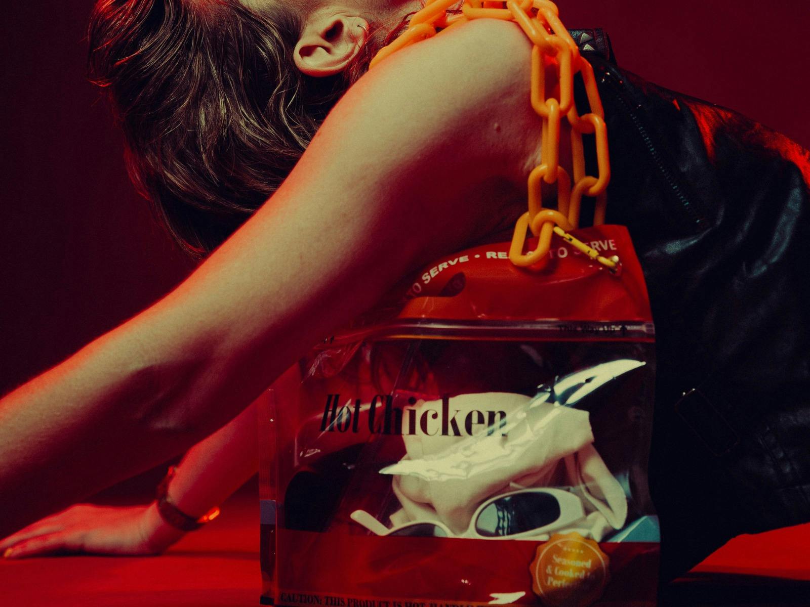 A hot chicken bag with a yellow chain shoulder strap