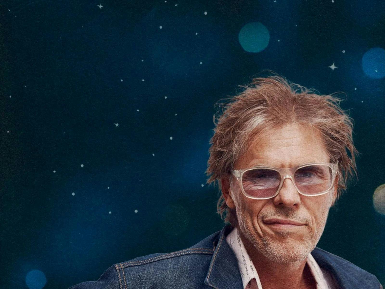 Tim Freedman against a dark starry background