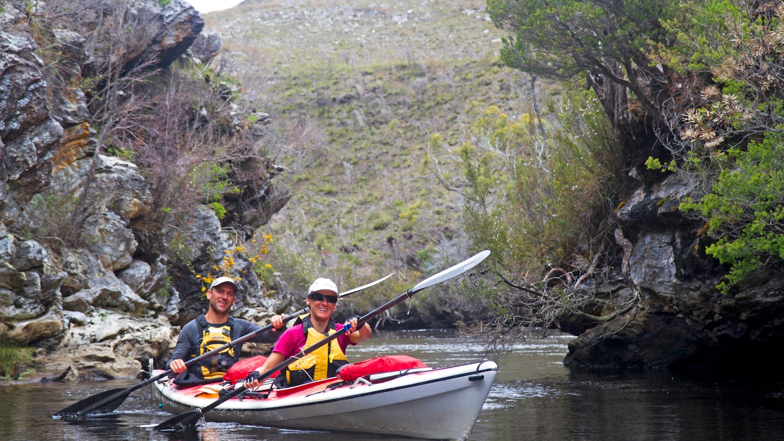 Kayakers on a remote river in Southwest Tasmania