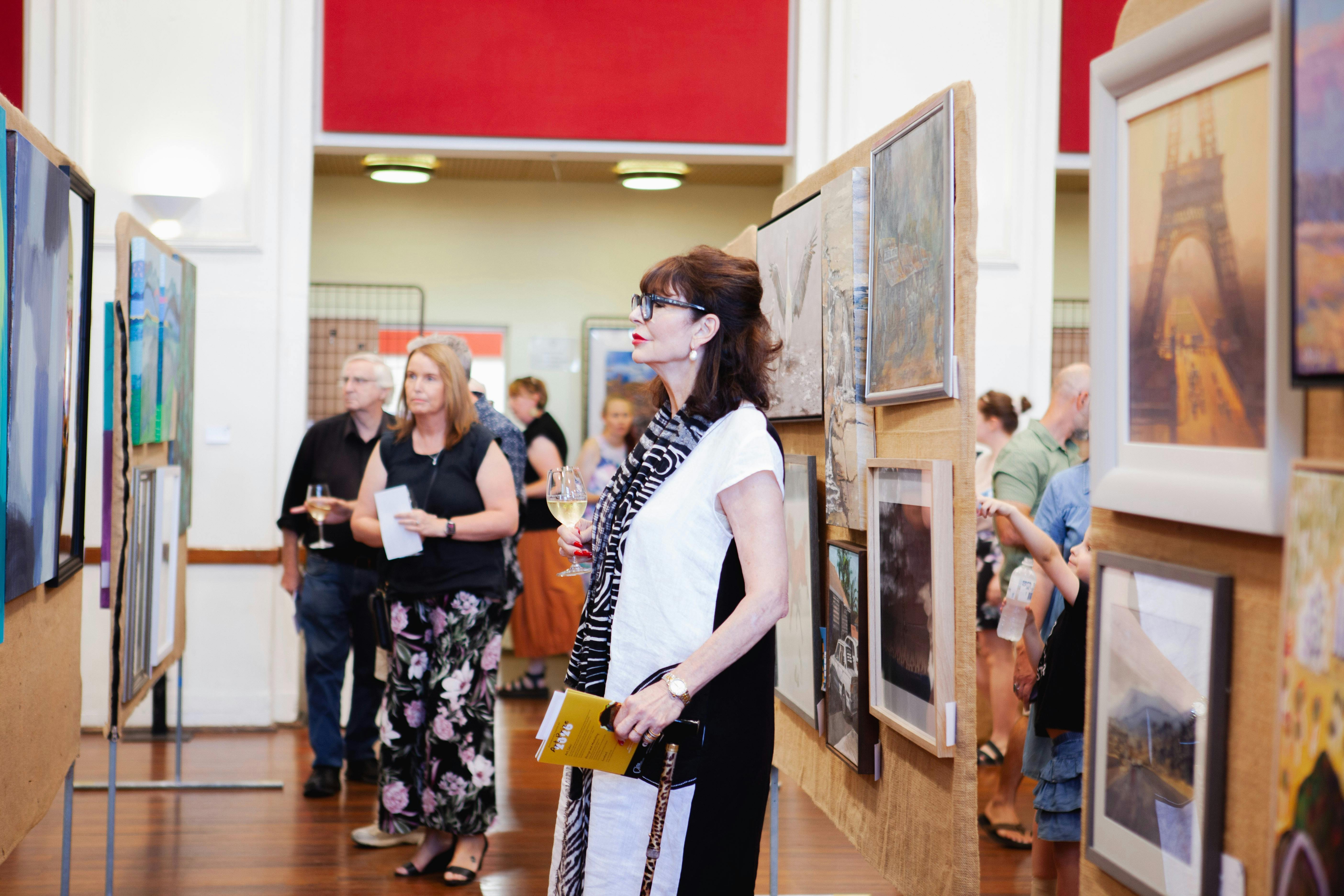 Lady looking intently at the art work