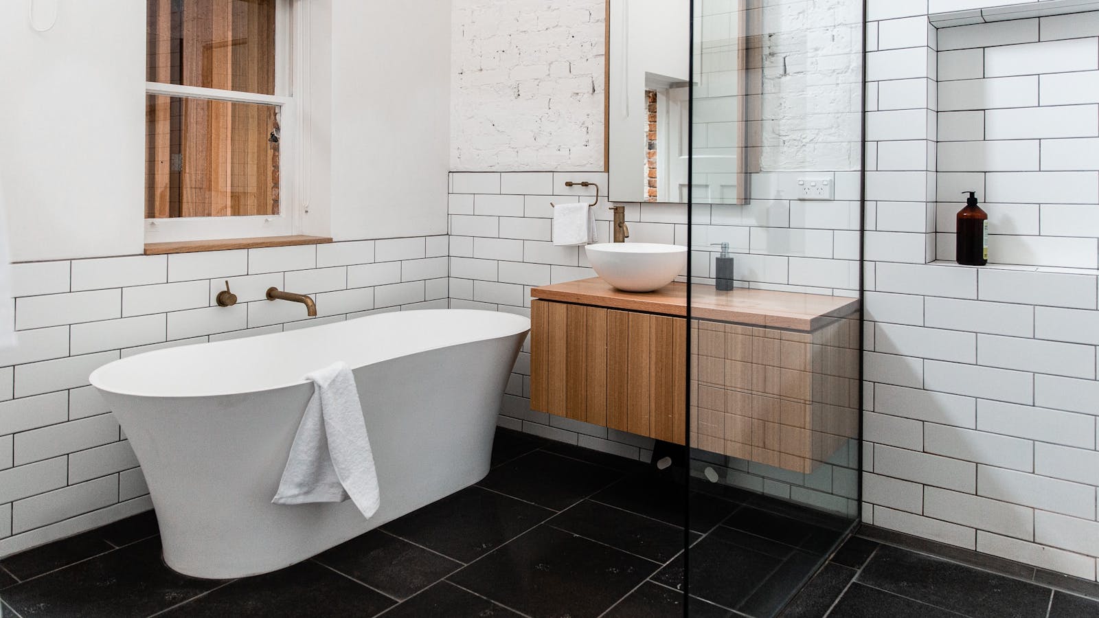 Main bathroom with luxury white-stone bath tub & walk-in shower