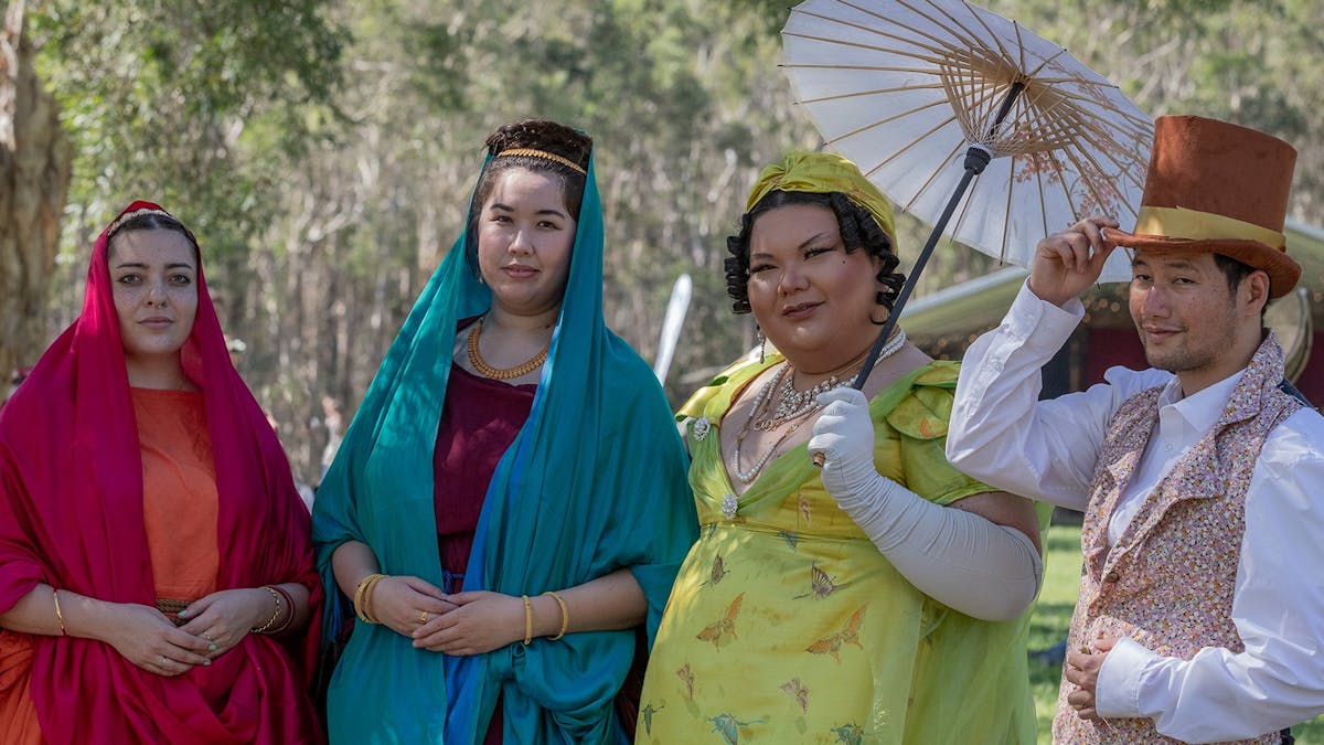four guests in colourful costuming