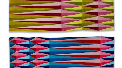 Rectangles of card, with undulating folds, and painted patterns of elongated lozenges, from above.