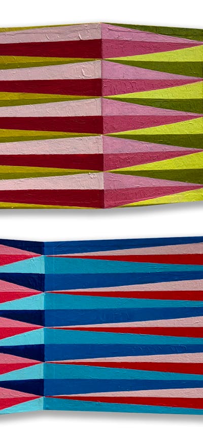 Rectangles of card, with undulating folds, and painted patterns of elongated lozenges, from above.