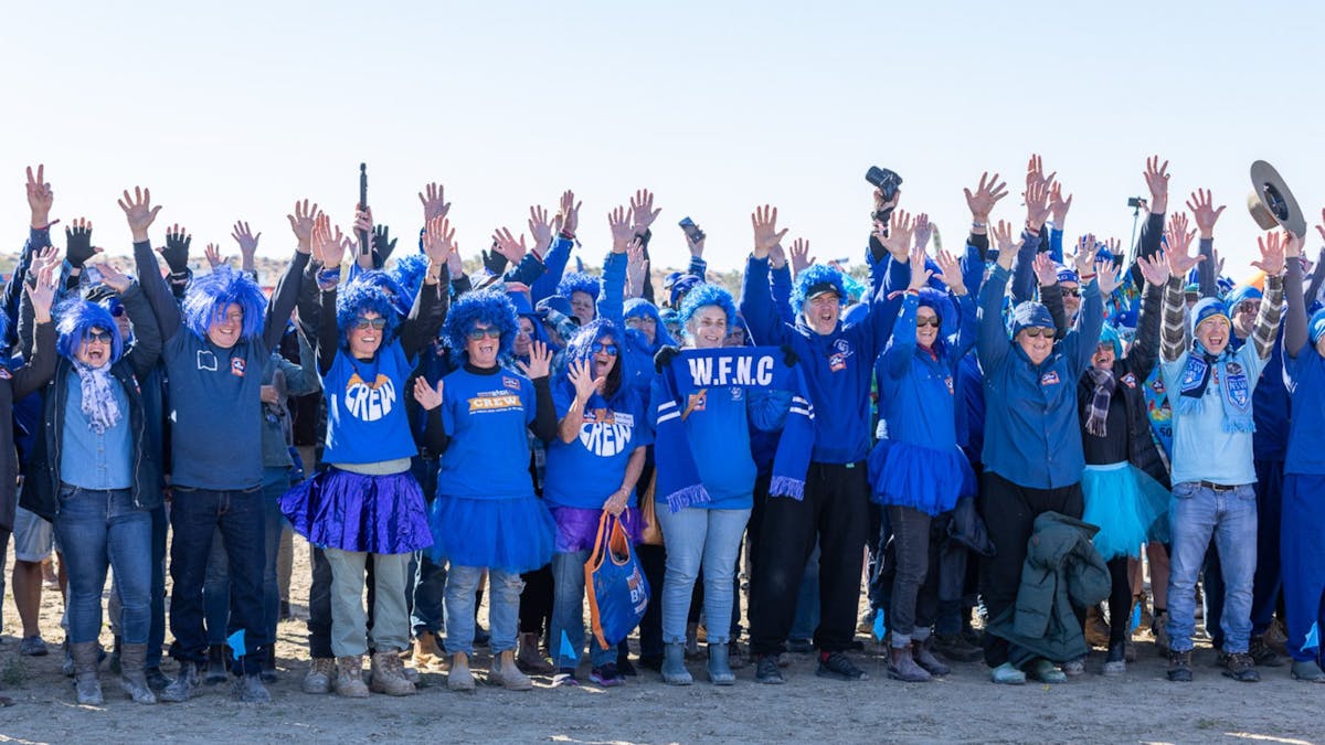 Big Red Bash festival goers dressed in blue supporting Breakthrough T1D at Big Blue Day, Birdsville