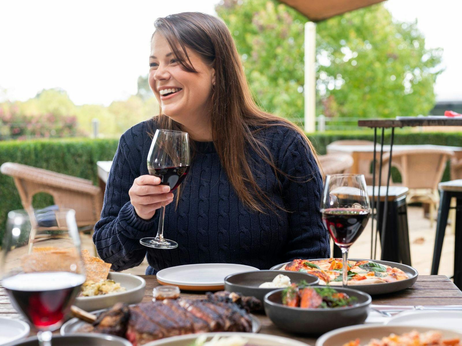 Woman with wine glass sitting at table