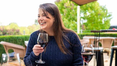 Woman with wine glass sitting at table