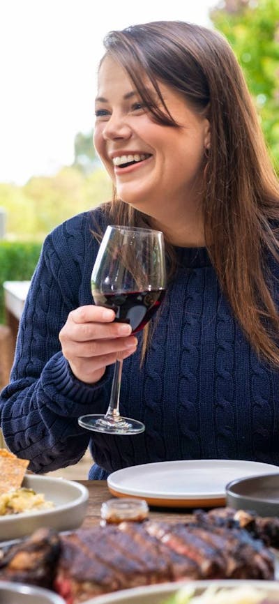 Woman with wine glass sitting at table