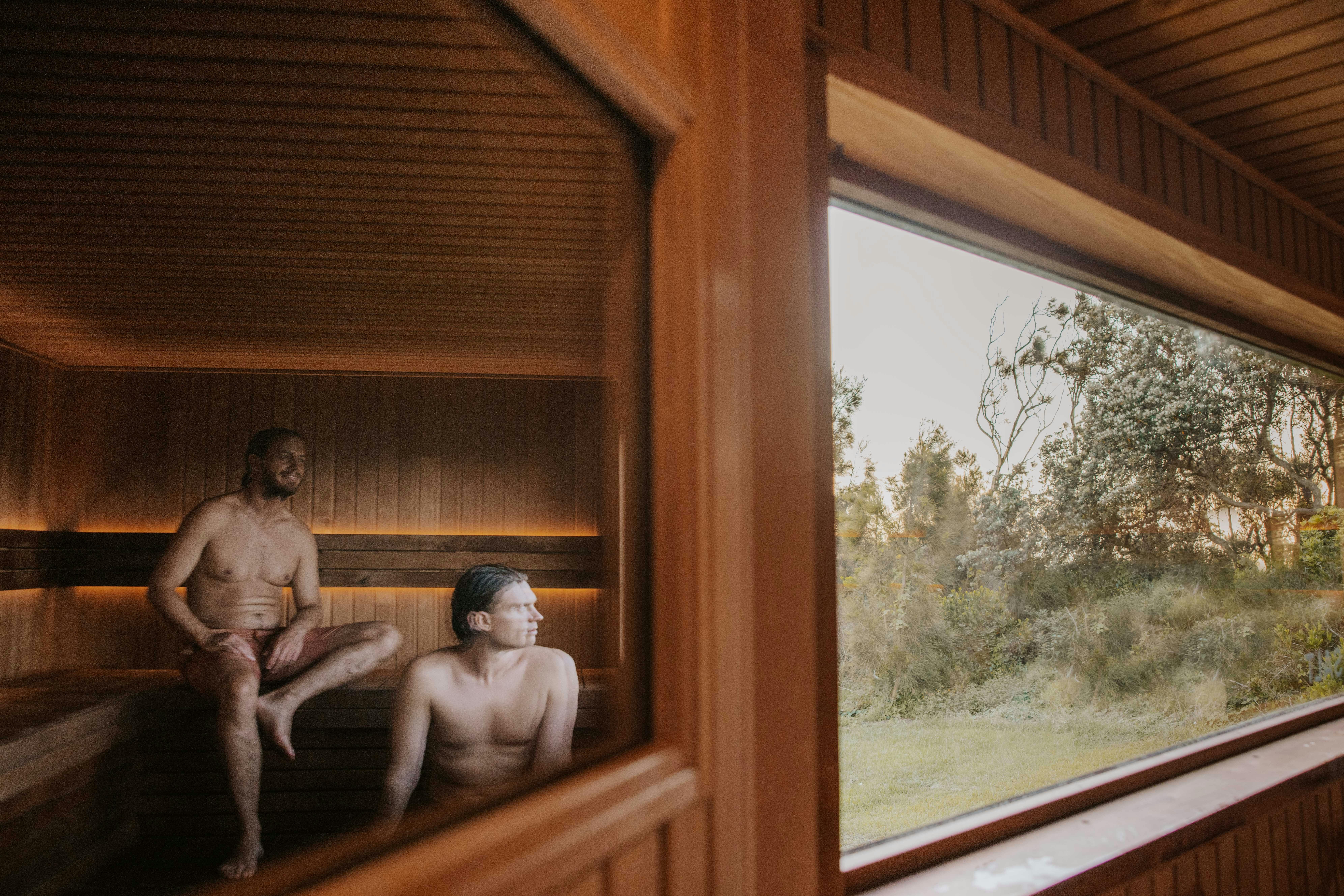 2 friends in a mobile outdoor woodfire sauna near manly looking out the window