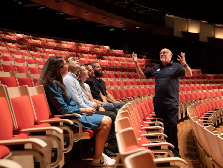 Tour guide with tour group inside Joan Sutherland Theatre