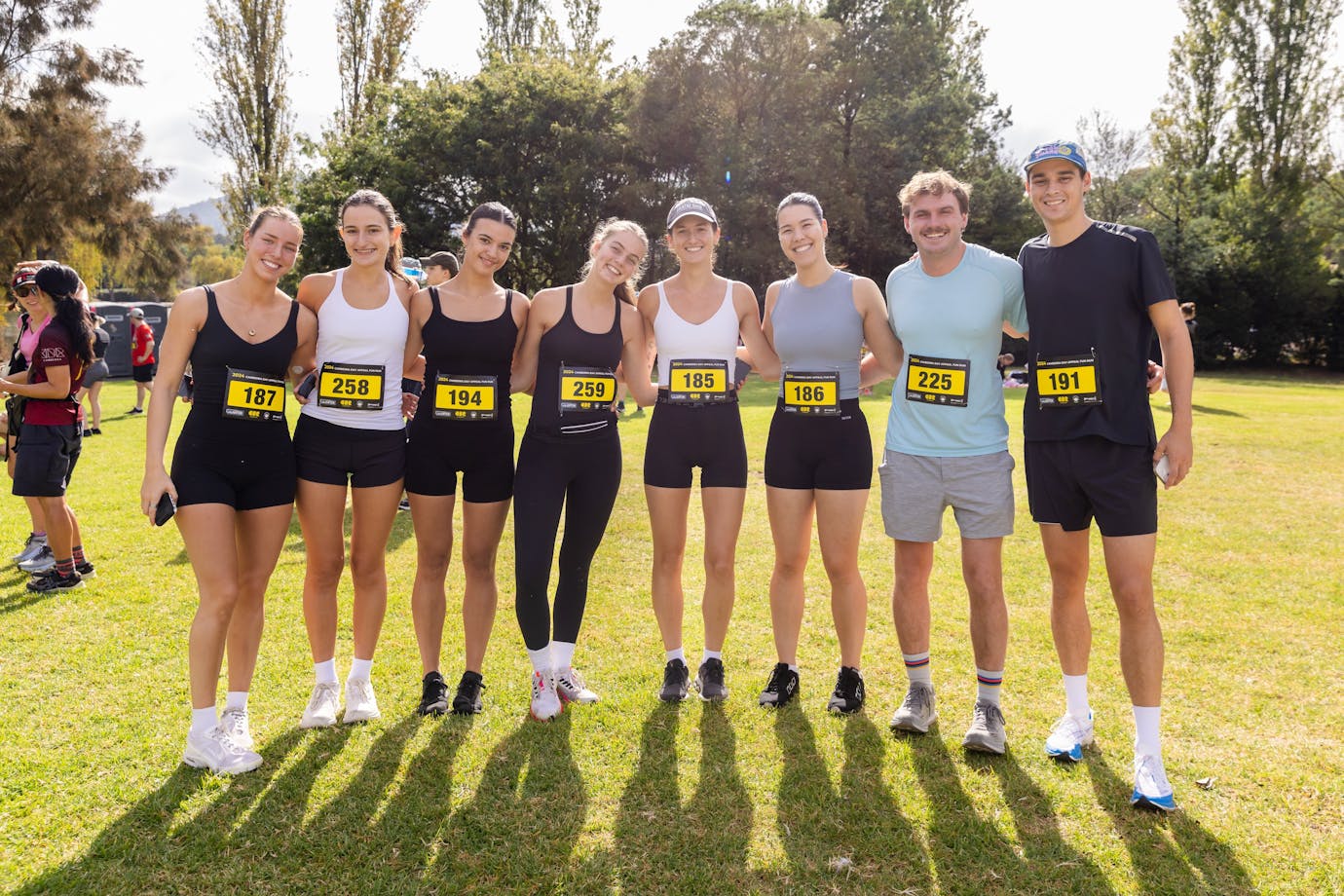 Group of people smiling to the camera, prior to participating in the fun run