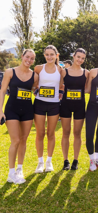 Group of people smiling to the camera, prior to participating in the fun run