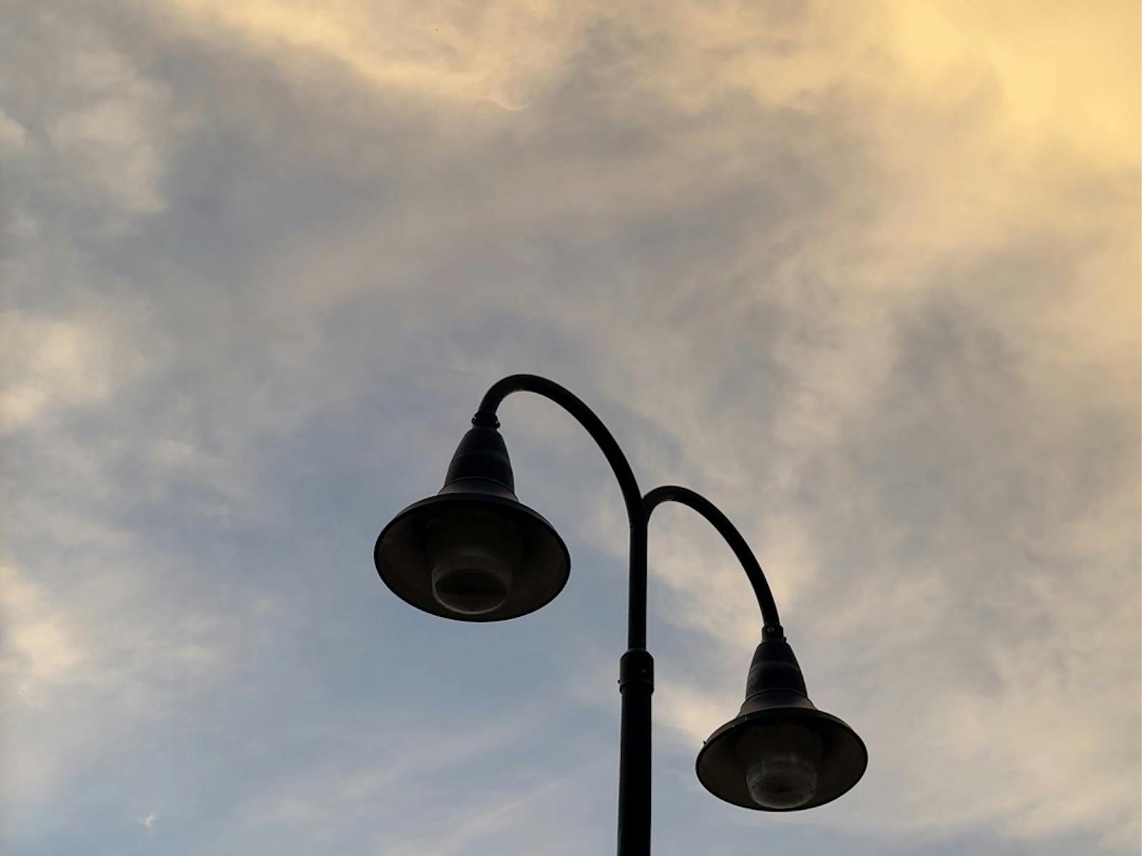 A lampost against a cloudy sunset