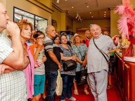 Threatre Historian Ivan King OAM showcases artifacts to a tour group in the theatre's Upper Circle.