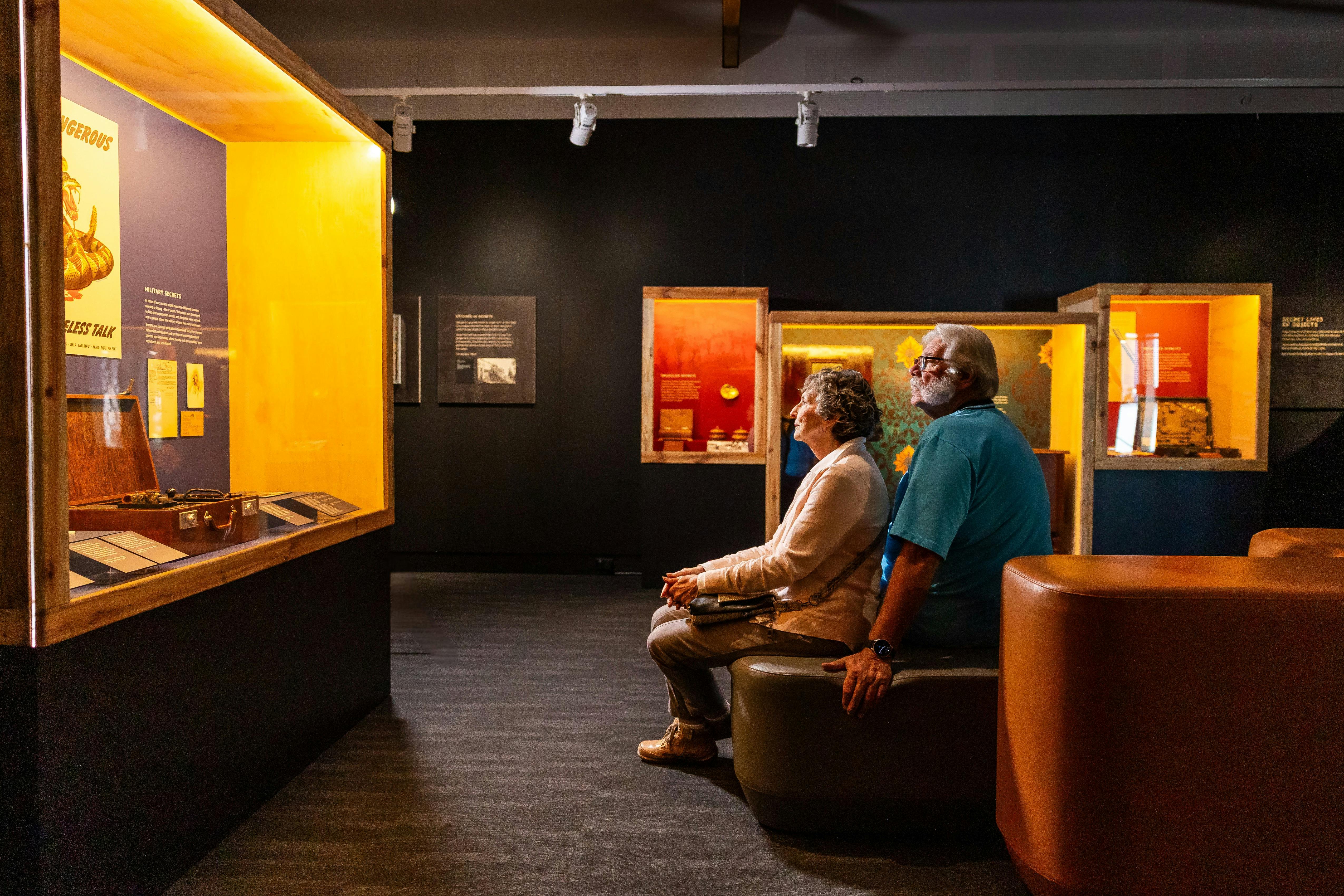 Senior aged couple sitting and reflecting in exhibition