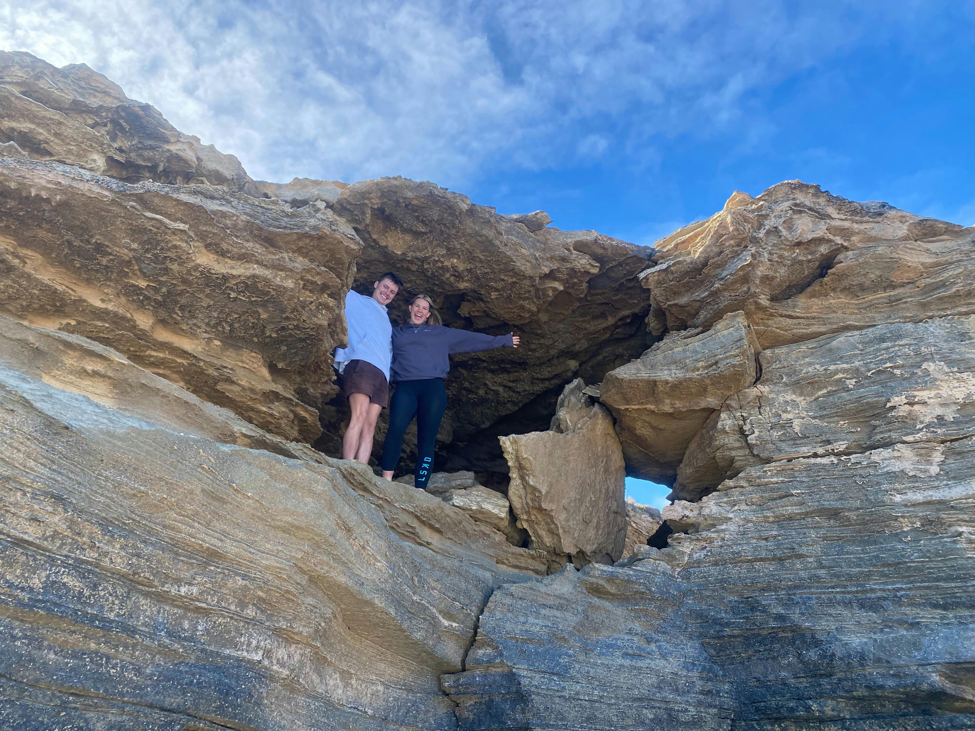 Customers combing through rock caves overlooking the southern ocean