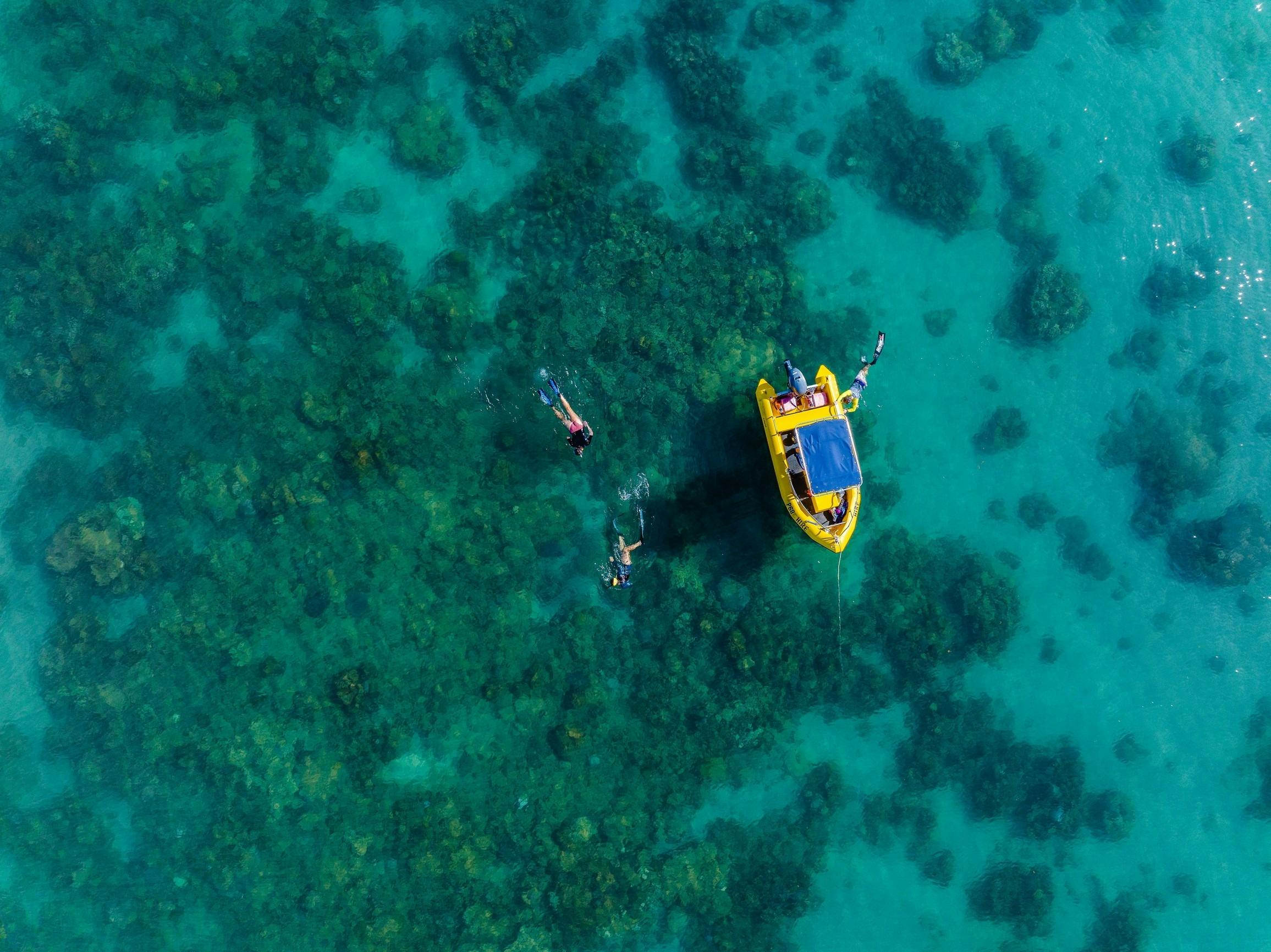 People swimming near their boat around the Mackerel Islands, near Onslow