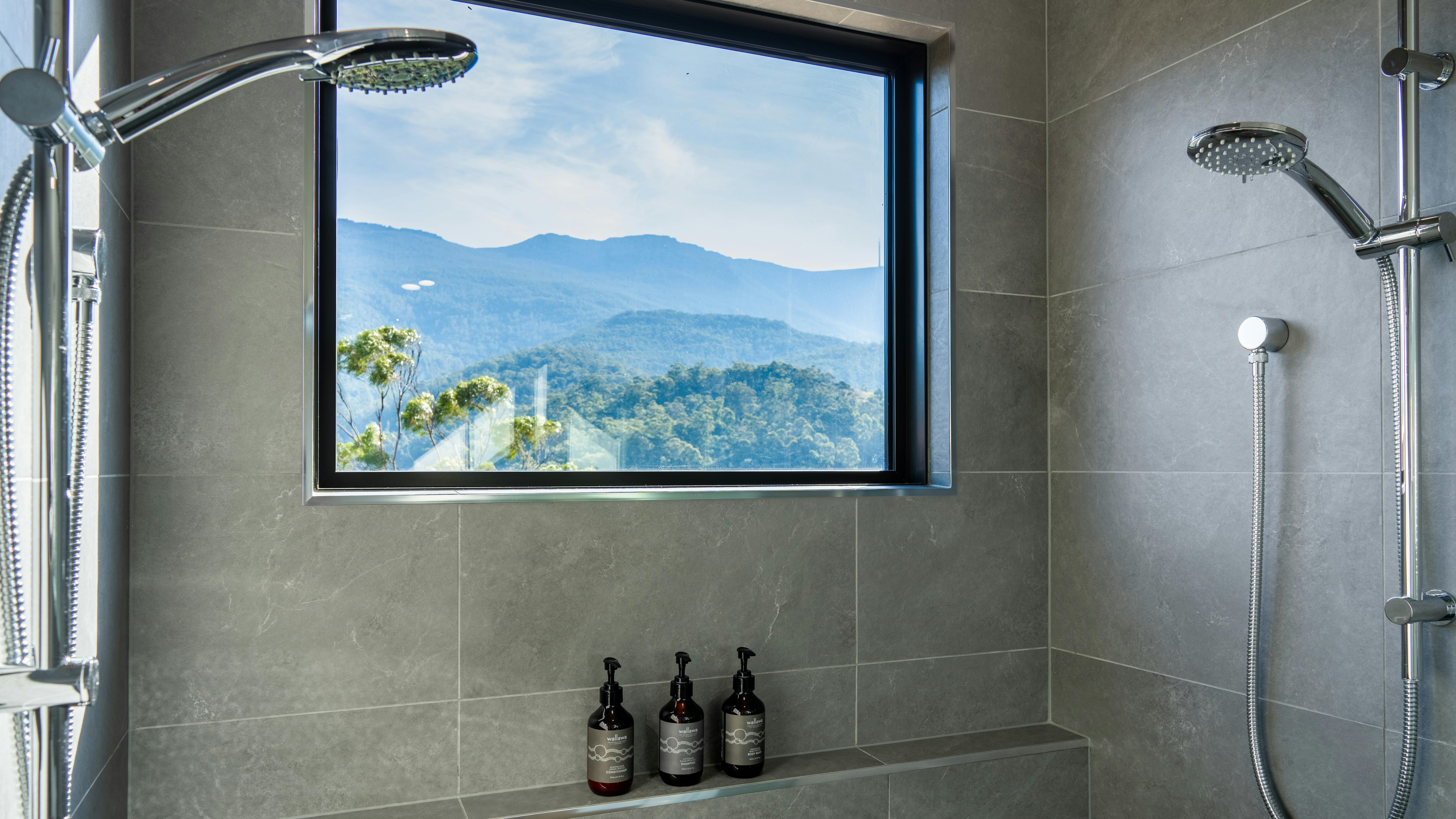 A double shower with a large window looking out to kunanyi / Mt Wellington
