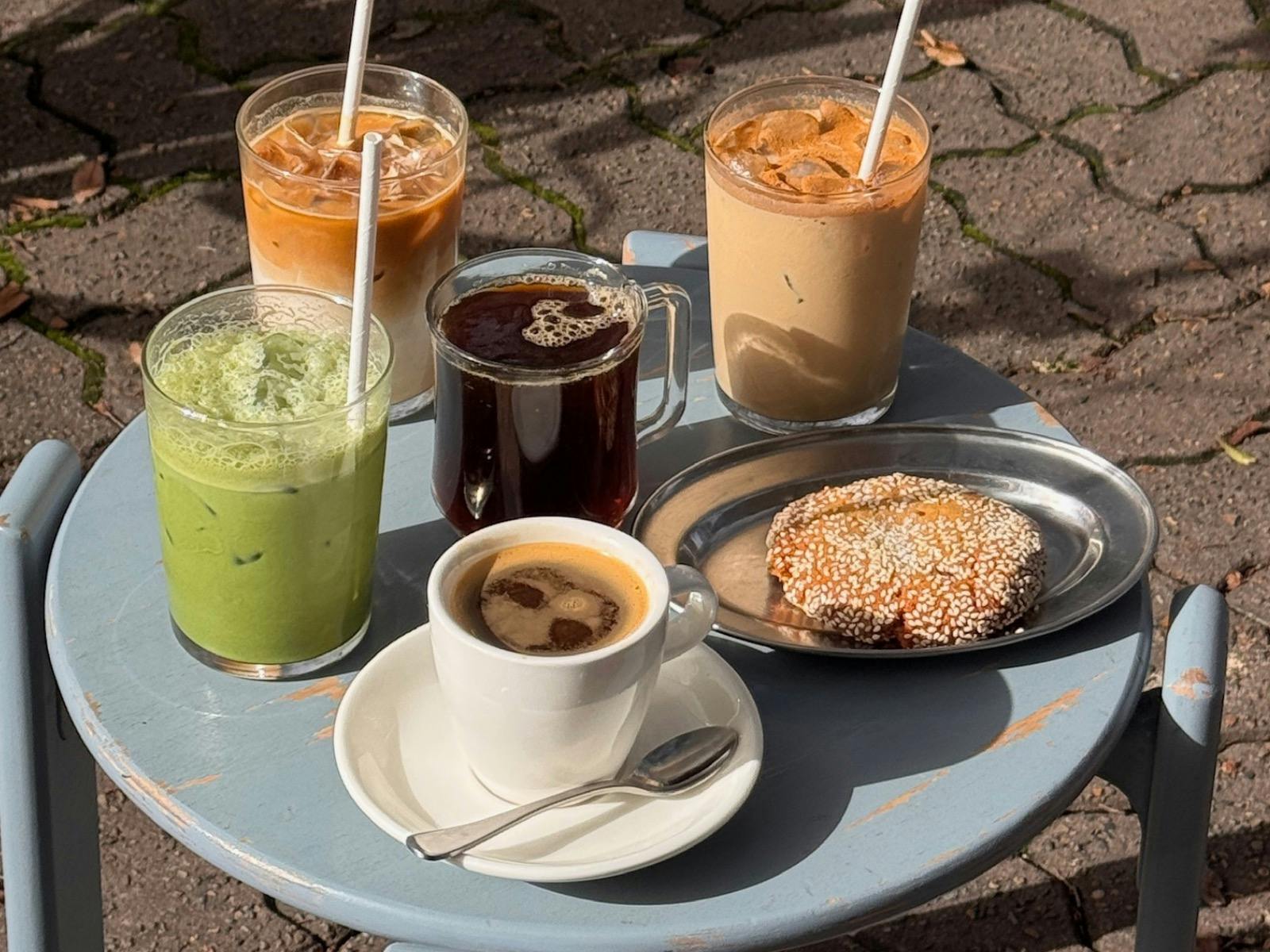 noon coffee selection including long black, iced latte, shaken tahini latte, long black and cookie