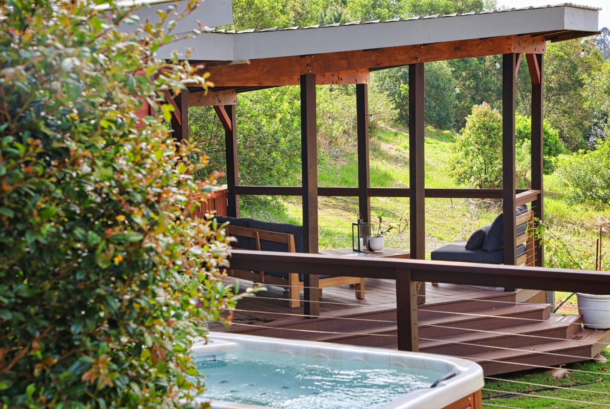 The private relaxation deck and magnesium spa, nestled among the hinterland gardens at The Range.