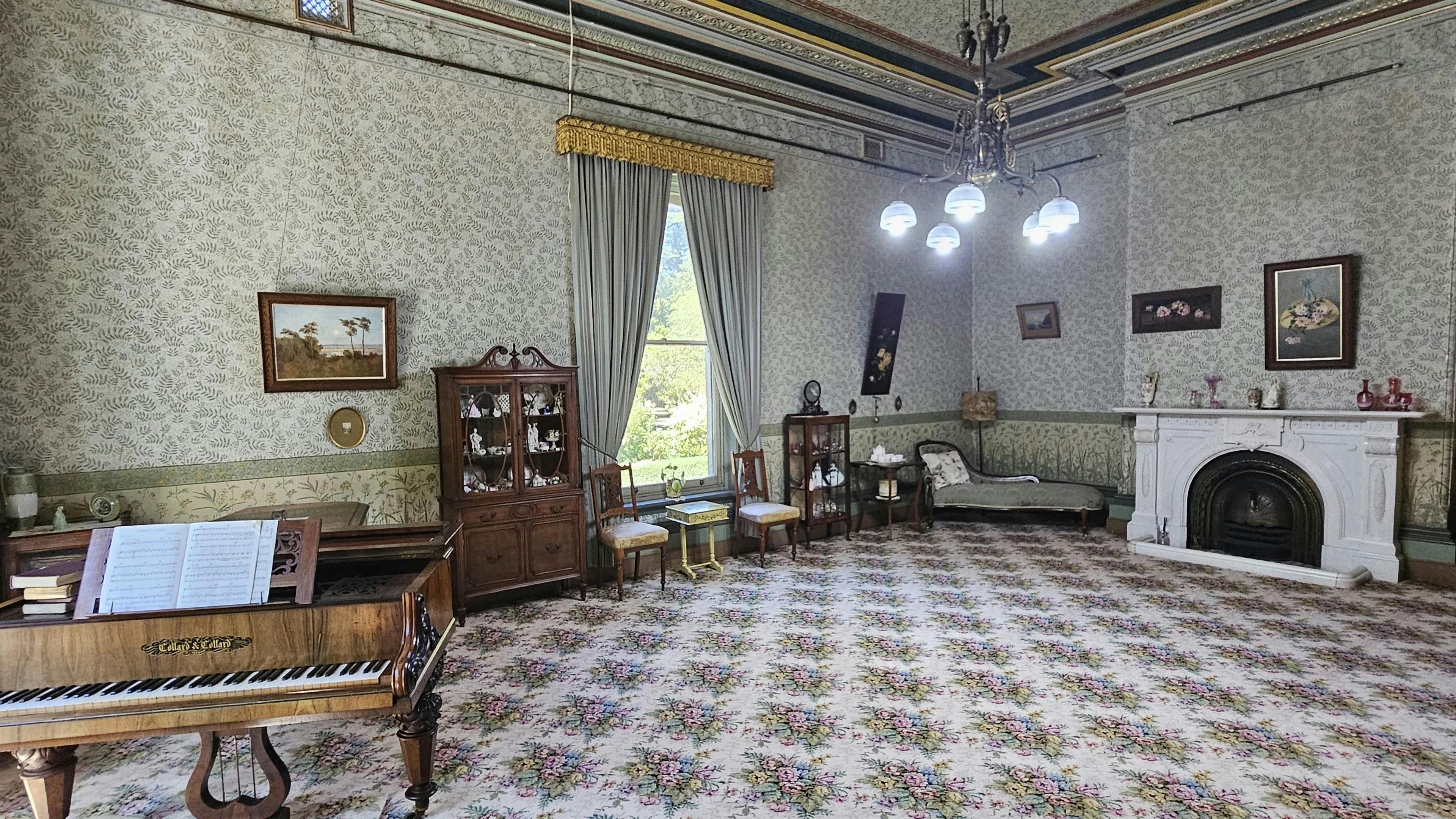 Yallum Park's drawing room with a grand piano, period furniture and chandelier
