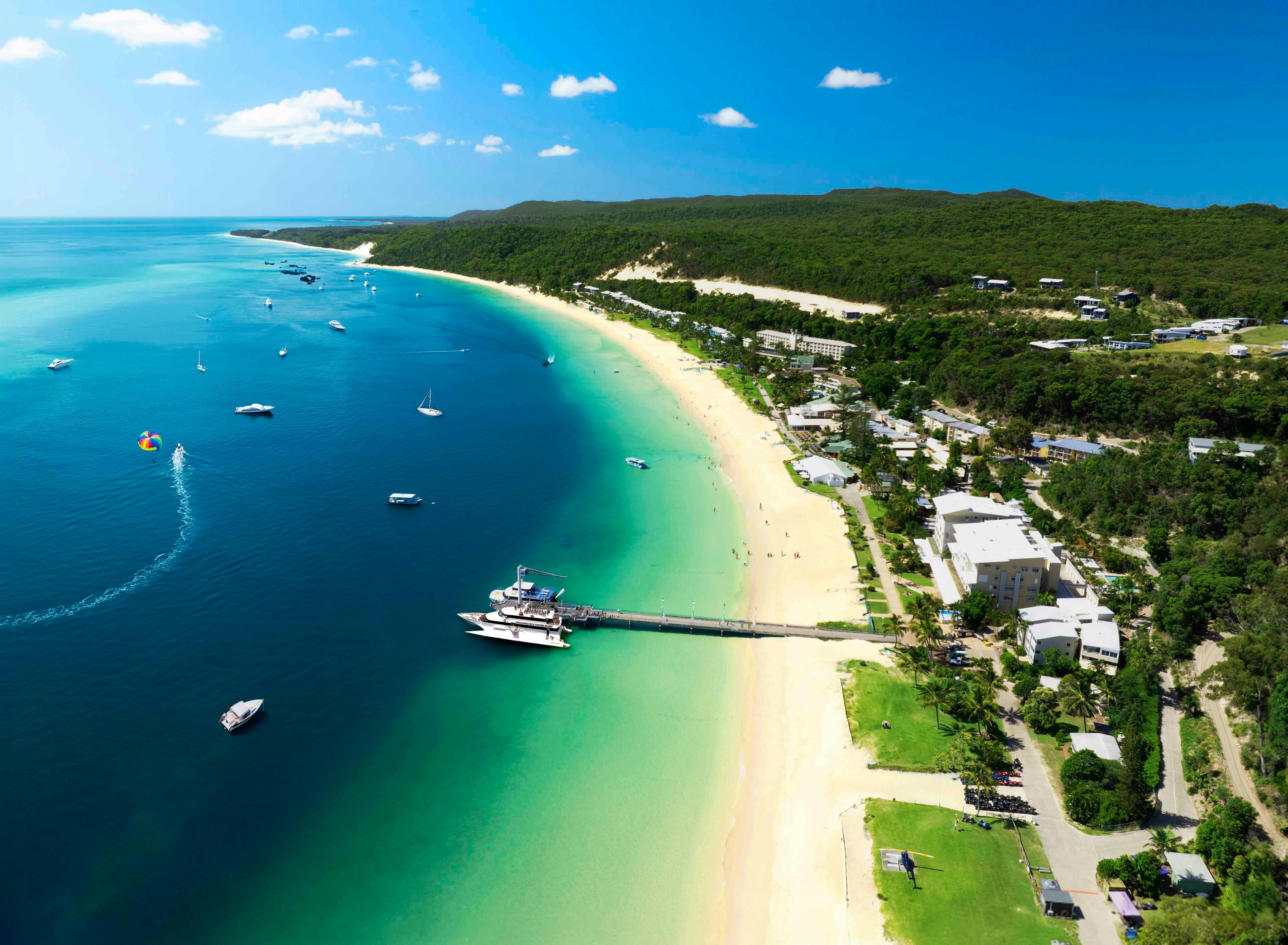 Aerial shot of Tangalooma Island Resort, the aqua water and the jetty