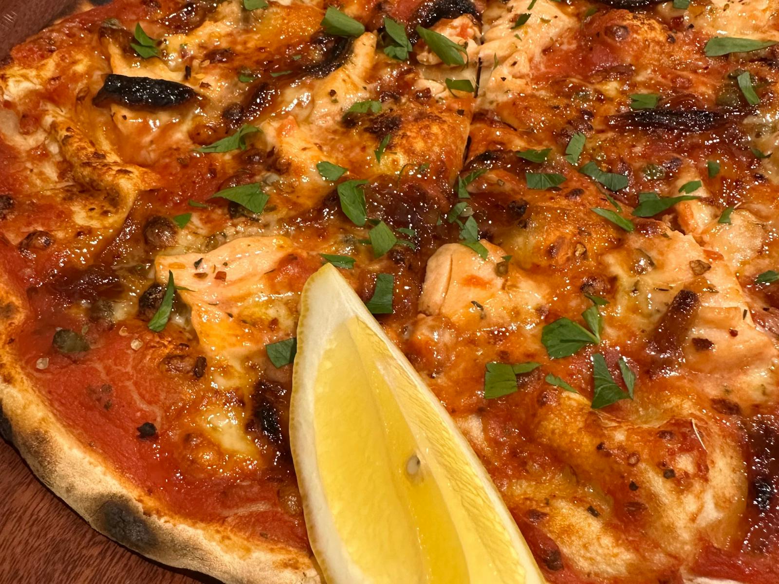 Fresh Salmon Fillet, sweet onion, chilli flakes on tomato base.