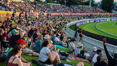 Fans watching the Big Bash on the hill at Manuka Oval