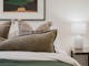 Bedroom with tableside lamp and painting