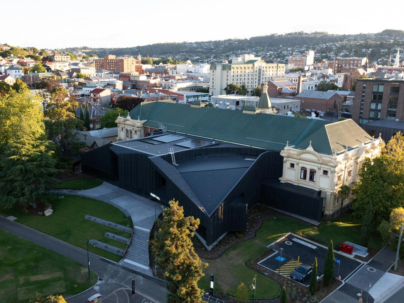 A birds eye view of a large building, anbd the surrounding area