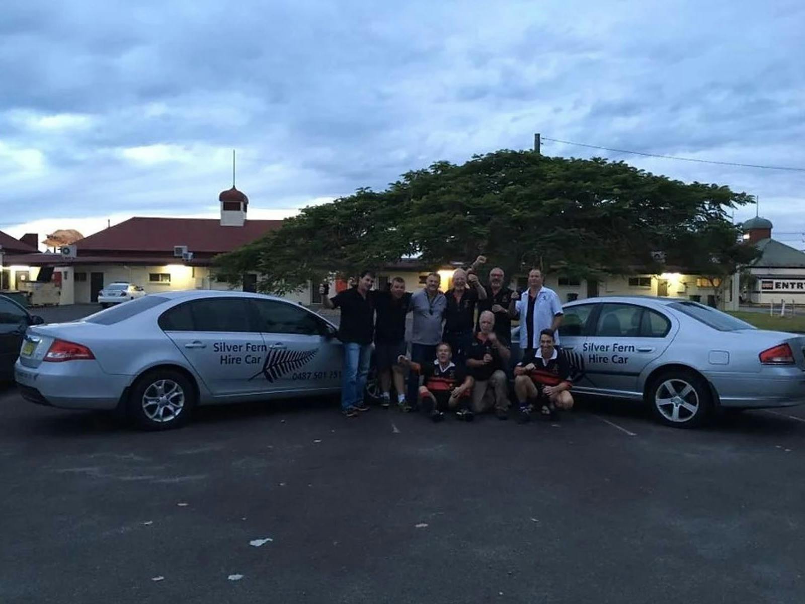2 cars with group of men