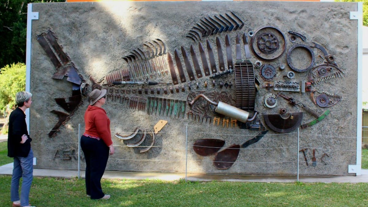 People admiring the Murray Cod sculpture