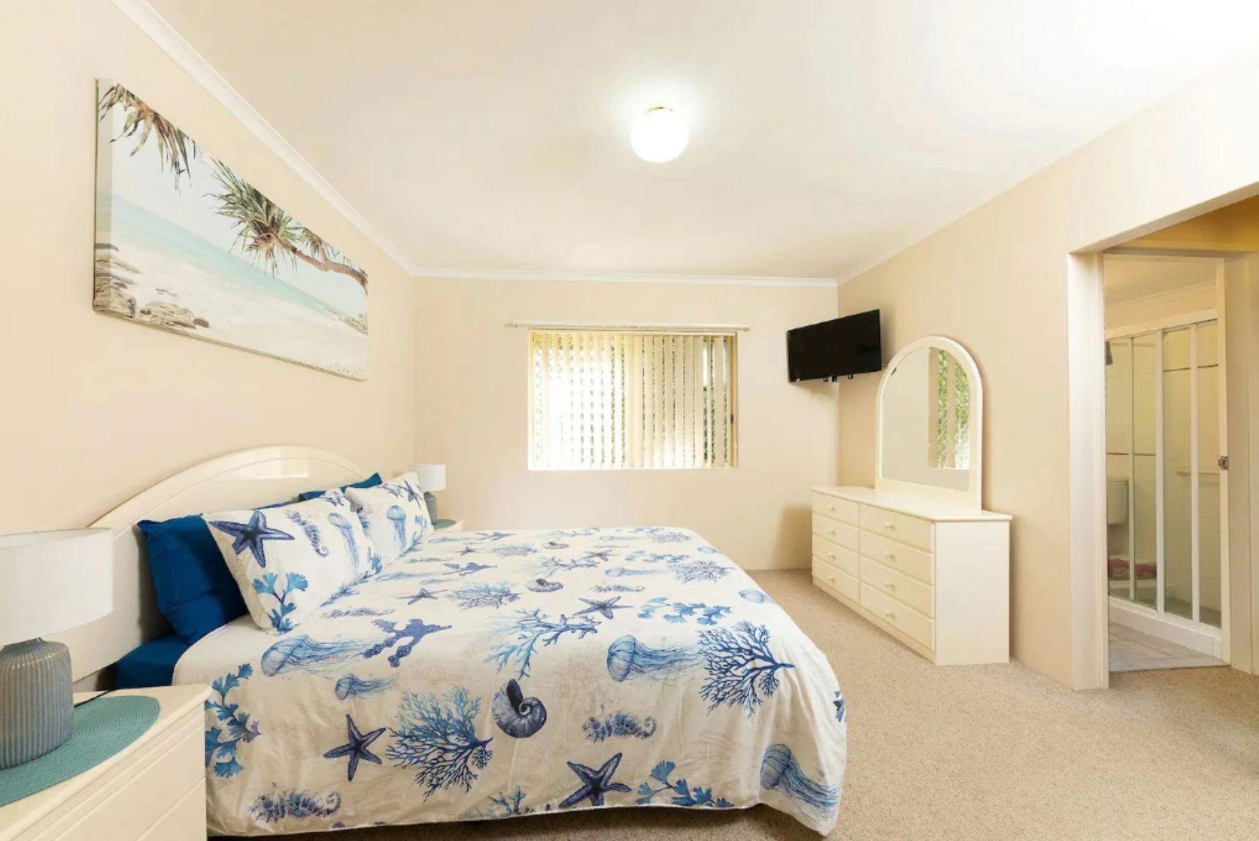 Master bedroom with Queen bed, TV and ensuite