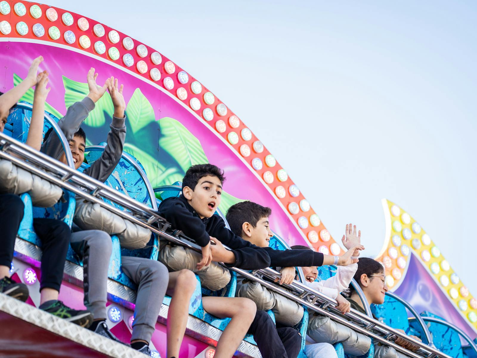 kids sitting on a carnival ride