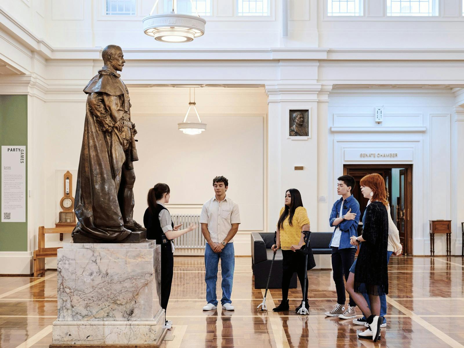 A group of people stand in King's Hall